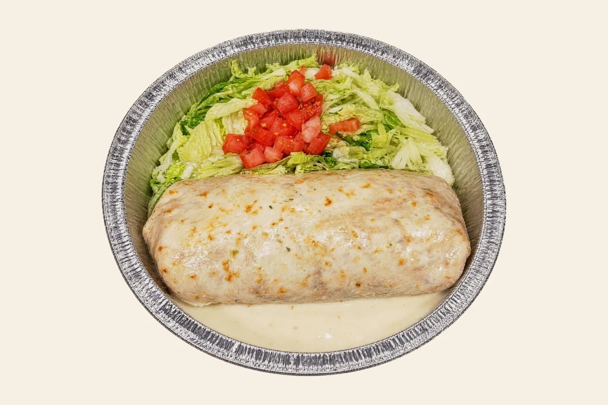 Burrito Loco smothered in white cheese sauce with lettuce and diced tomato
