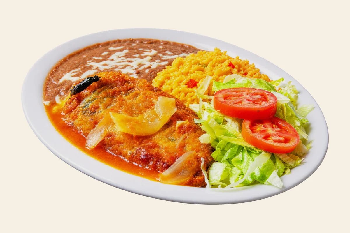 Chile relleno in ranchero sauce with refried beans, Mexican rice, lettuce and tomato