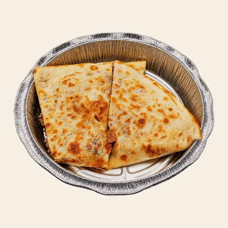 Quesadilla grande cut in half in a foil tray
